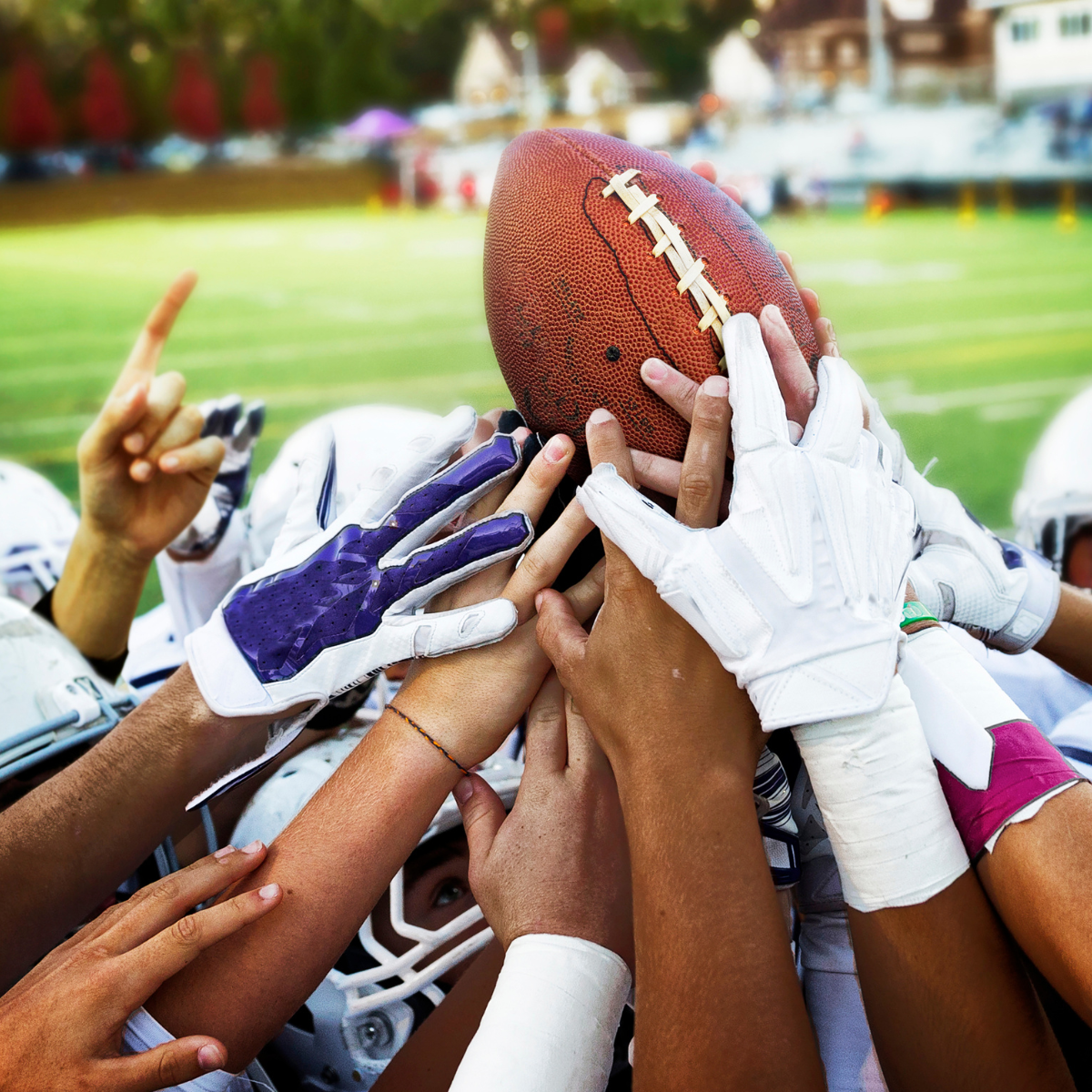 May contain: people, person, body part, finger, hand, helmet, american football, football, playing american football, sport, american football (ball), and ball