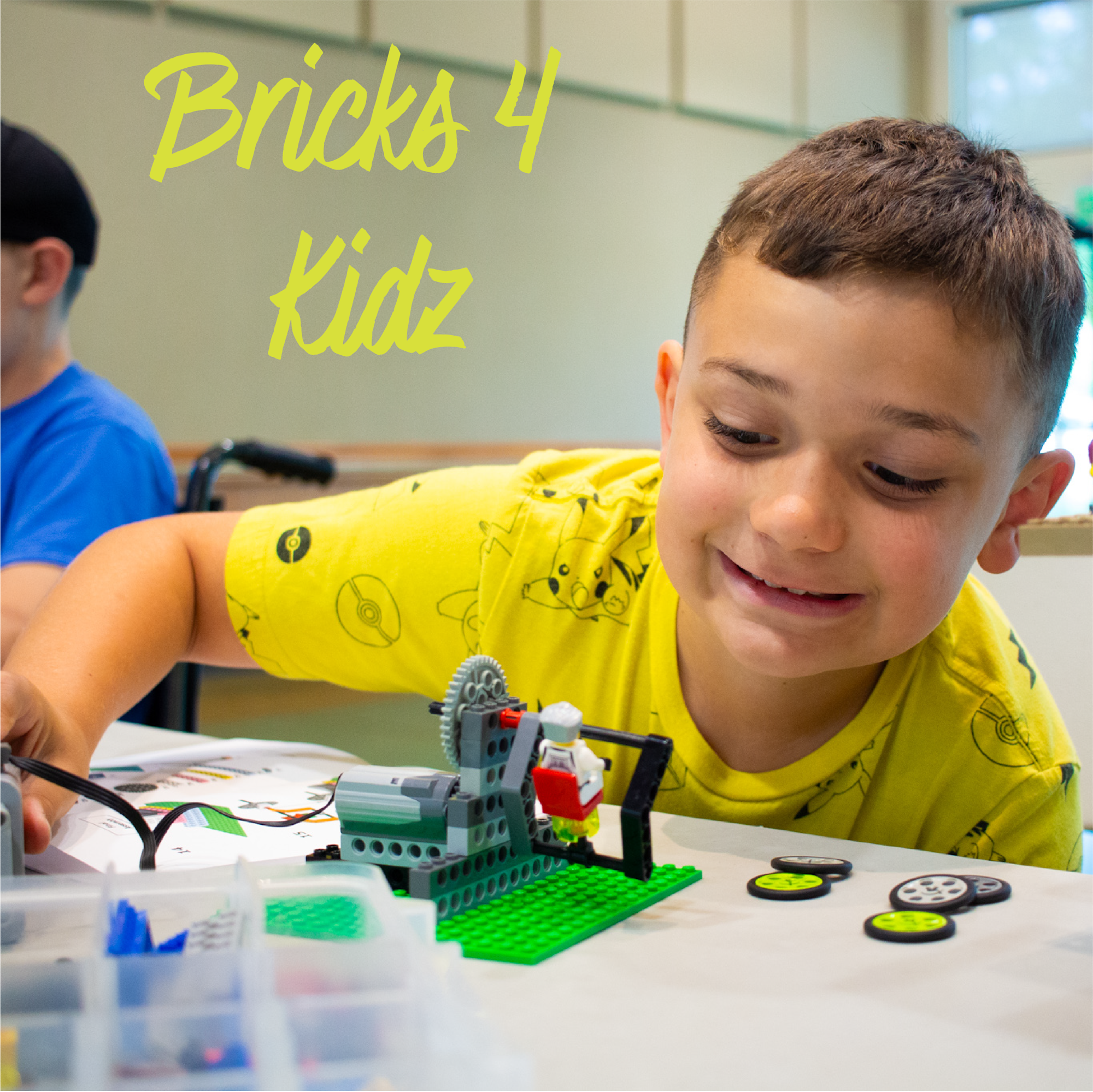 A child in a yellow shirt building with LEGO bricks at a "Bricks 4 Kidz" event.
