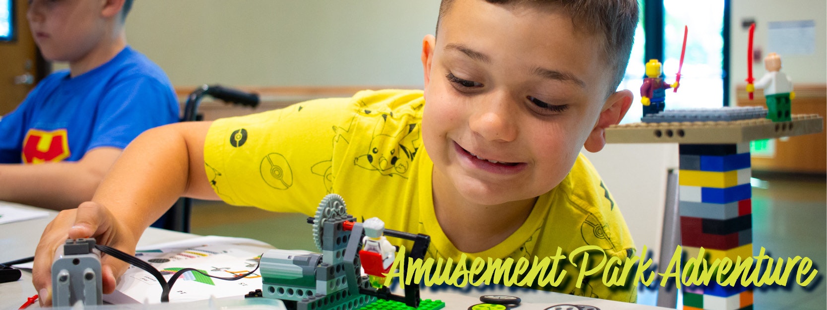 Child smiling, playing with LEGO in a yellow Pokémon shirt. Text: "Amusement Park Adventure."
