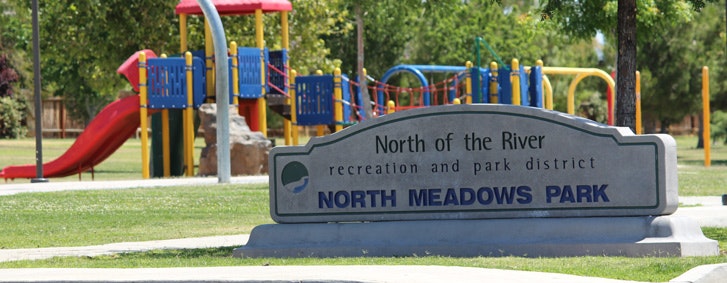 May contain: entrance sign to a park, playground, outdoors