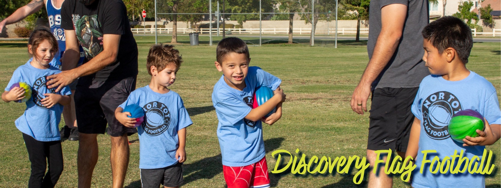 Kids playing flag football, wearing blue shirts, holding colorful balls, with adults nearby. Text reads "Discovery Flag Football."
