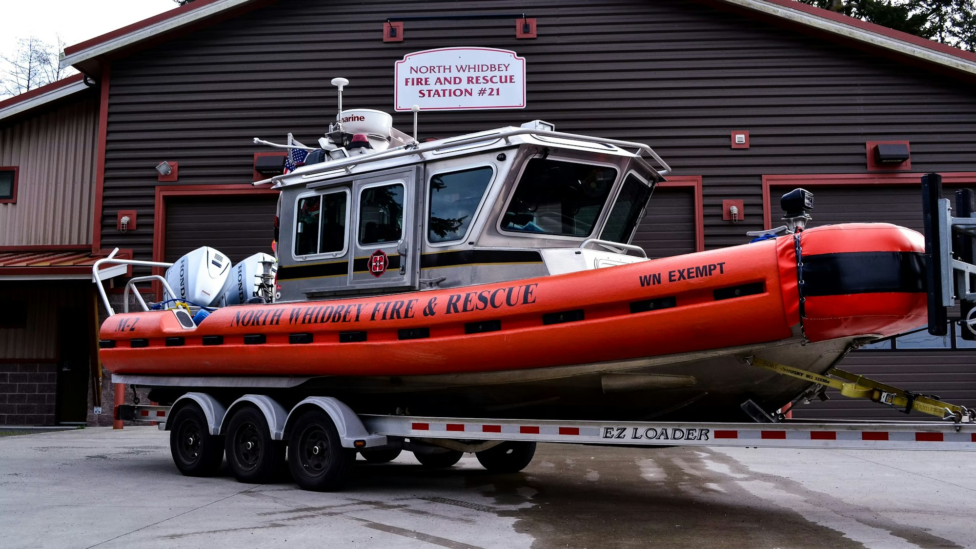 A North Whidbey Fire & Rescue boat on a trailer in front of Fire and Rescue Station #21.