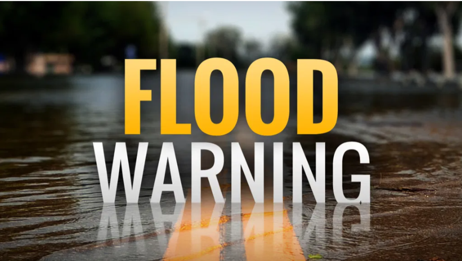 Text "Flood Warning" over a wet, flooded road background.