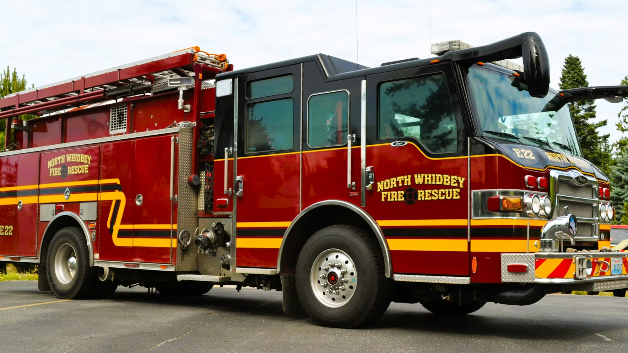 A red fire truck from North Whidbey Fire Rescue parked on a road.