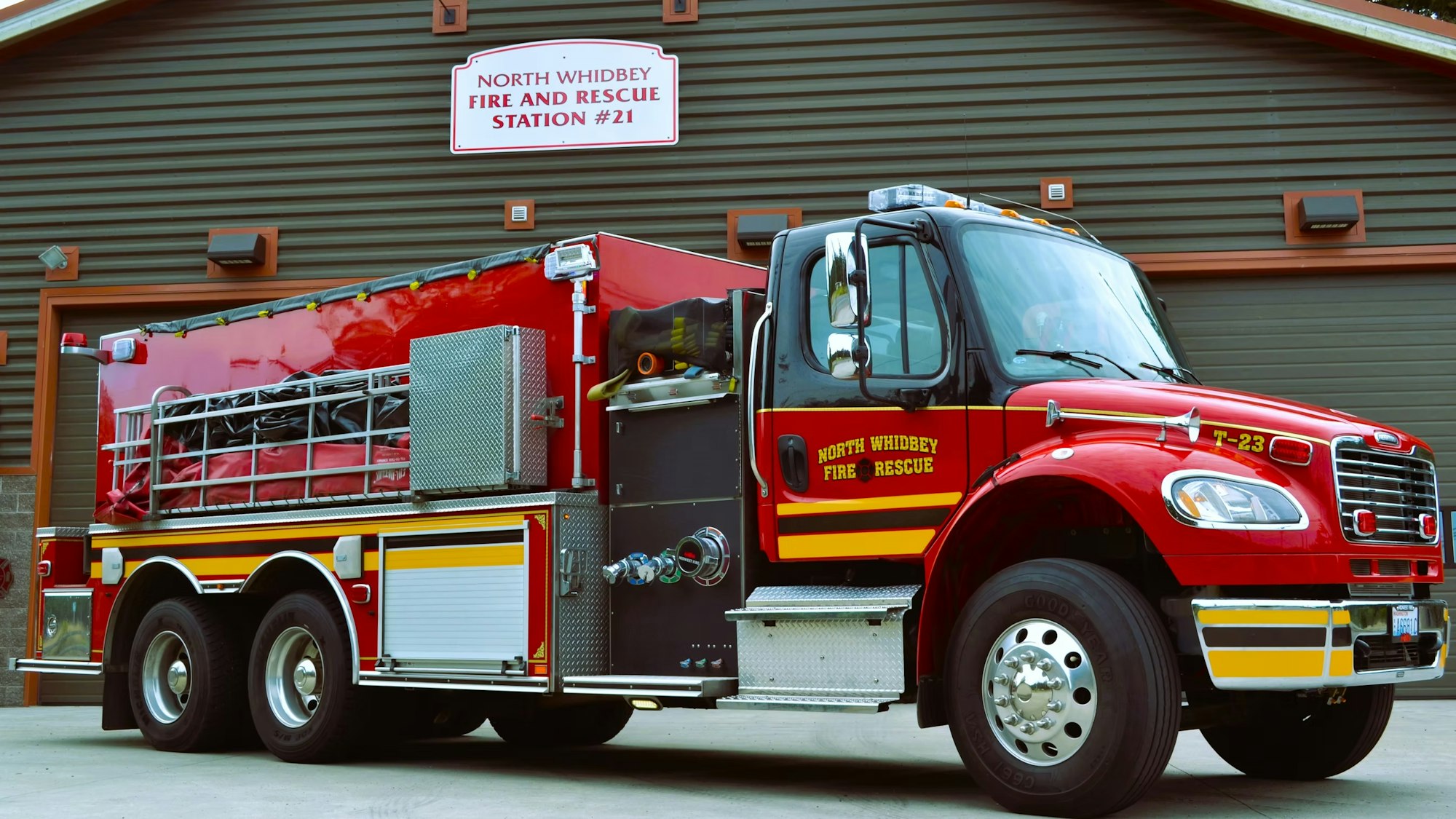 A red fire truck is parked in front of North Whidbey Fire and Rescue Station #21.