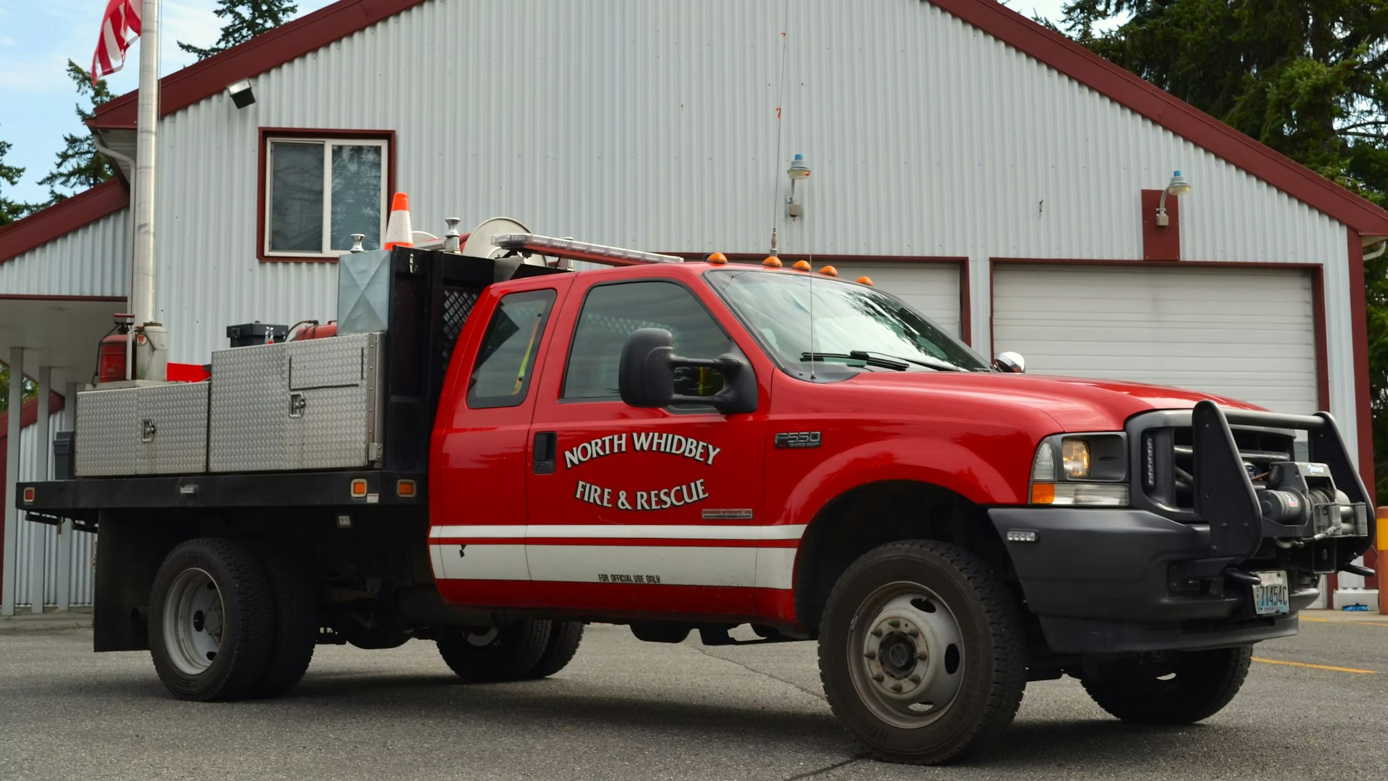 Red fire and rescue truck parked in front of a building, labeled "North Whidbey Fire & Rescue."