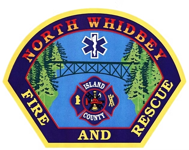 Logo for North Whidbey Fire and Rescue featuring trees, a bridge, and emergency symbols over a blue background.