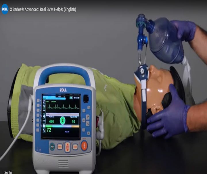 Medical simulation: a mannequin receives ventilation with a bag valve mask. A monitoring device displays vital signs.