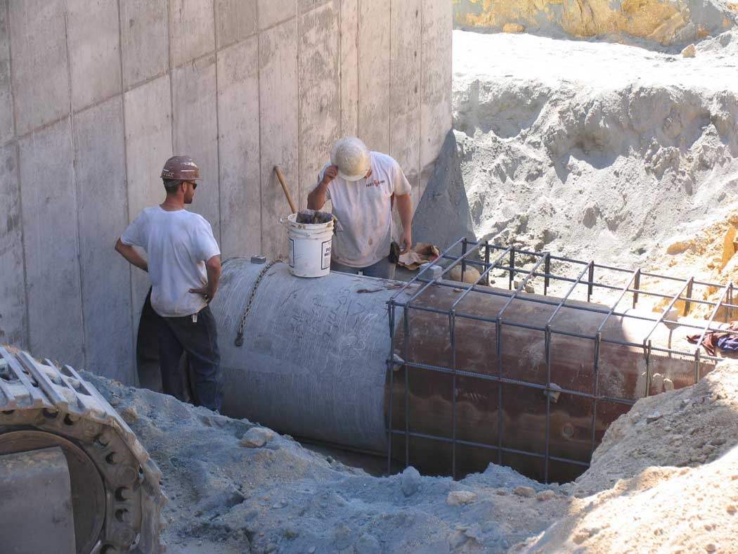 Two workers and construction materials at a building site.