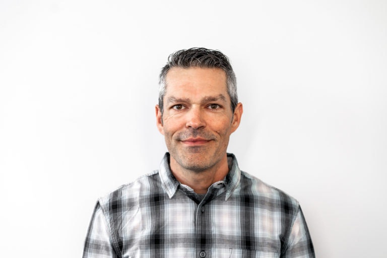 May contain: face, head, person, photography, portrait, happy, smile, clothing, shirt, adult, male, and man