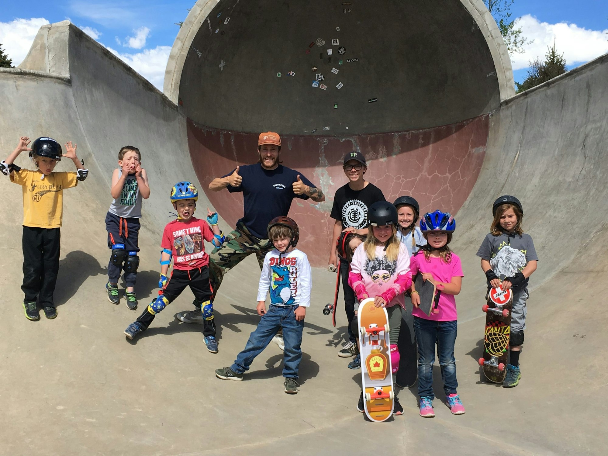 May contain: photography, people, person, helmet, clothing, pants, footwear, shoe, glove, boy, child, male, adult, female, woman, face, head, portrait, hat, accessories, glasses, man, skateboard, t-shirt, and jeans