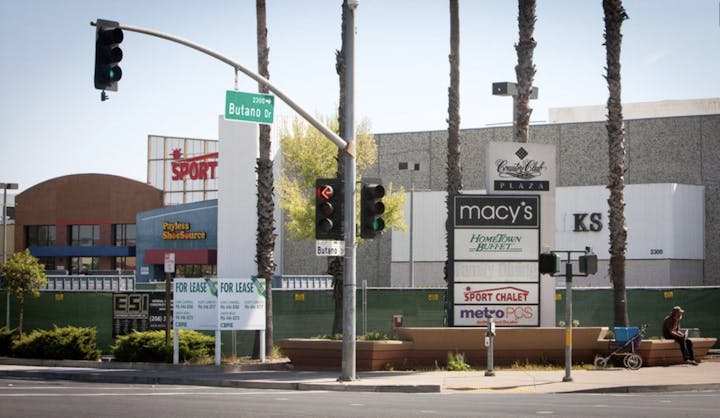 Street scene from 2008/2009 with traffic lights and signs for Macy's, Payless ShoeSource, Sport Chalet, and more at Country Club Plaza, Butano Drive.