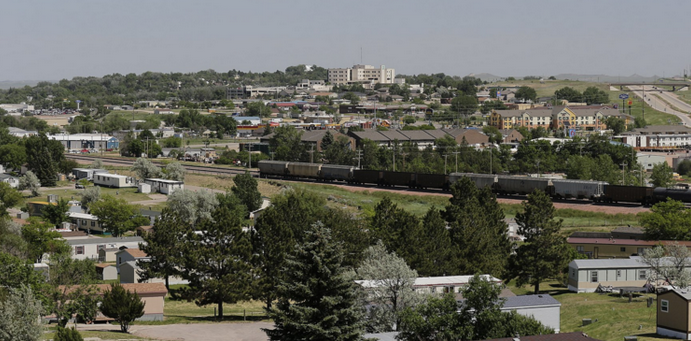 May contain: urban, rail, transportation, train track, railway, neighborhood, building, plant, tree, fir, and abies