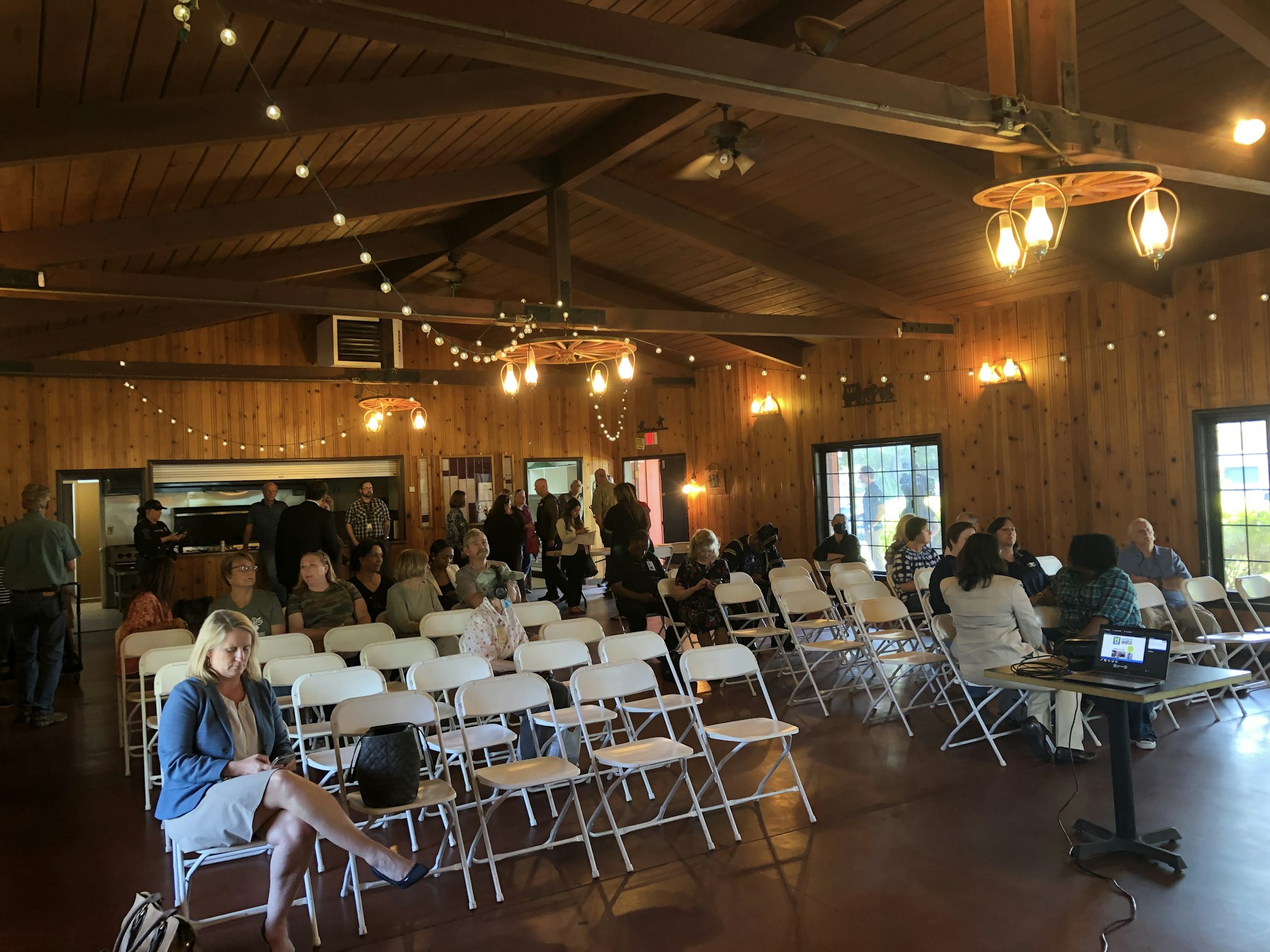 May contain: people, person, adult, female, woman, accessories, bag, handbag, clothing, hat, male, man, architecture, building, college, chair, furniture, indoors, crowd, glasses, footwear, and shoe