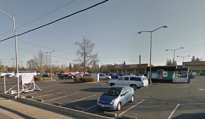 The image shows a parking lot with various vehicles, a "For Lease" sign, and a store called Smart & Final, along with a coffee stand.