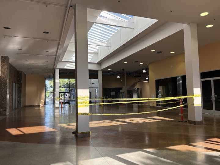 The north lobby of Country Club Plaza, with yellow caution tape, pillars, and skylights