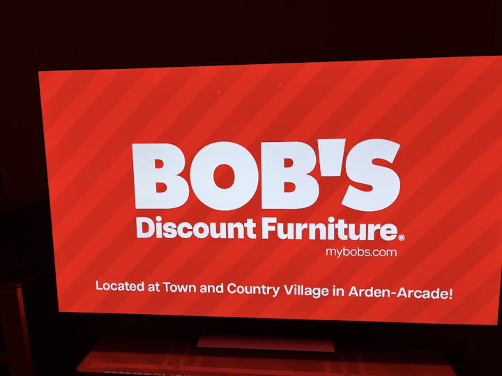 The image displays an advertisement for Bob's Discount Furniture, highlighting its location in Arden-Arcade.