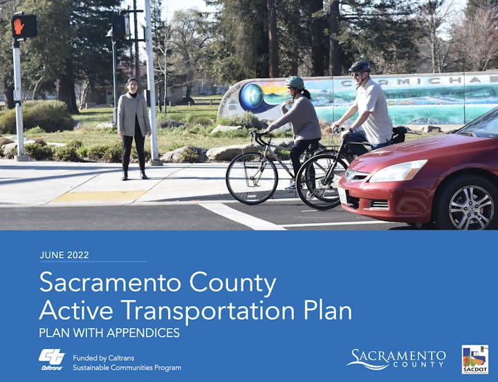 Image features a transportation plan for Sacramento County, highlighting active transit with pedestrians and cyclists at a crosswalk.