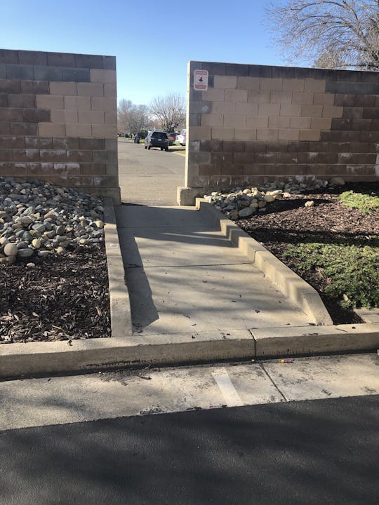 photo of architectural barrier between street and pedestrian ramp