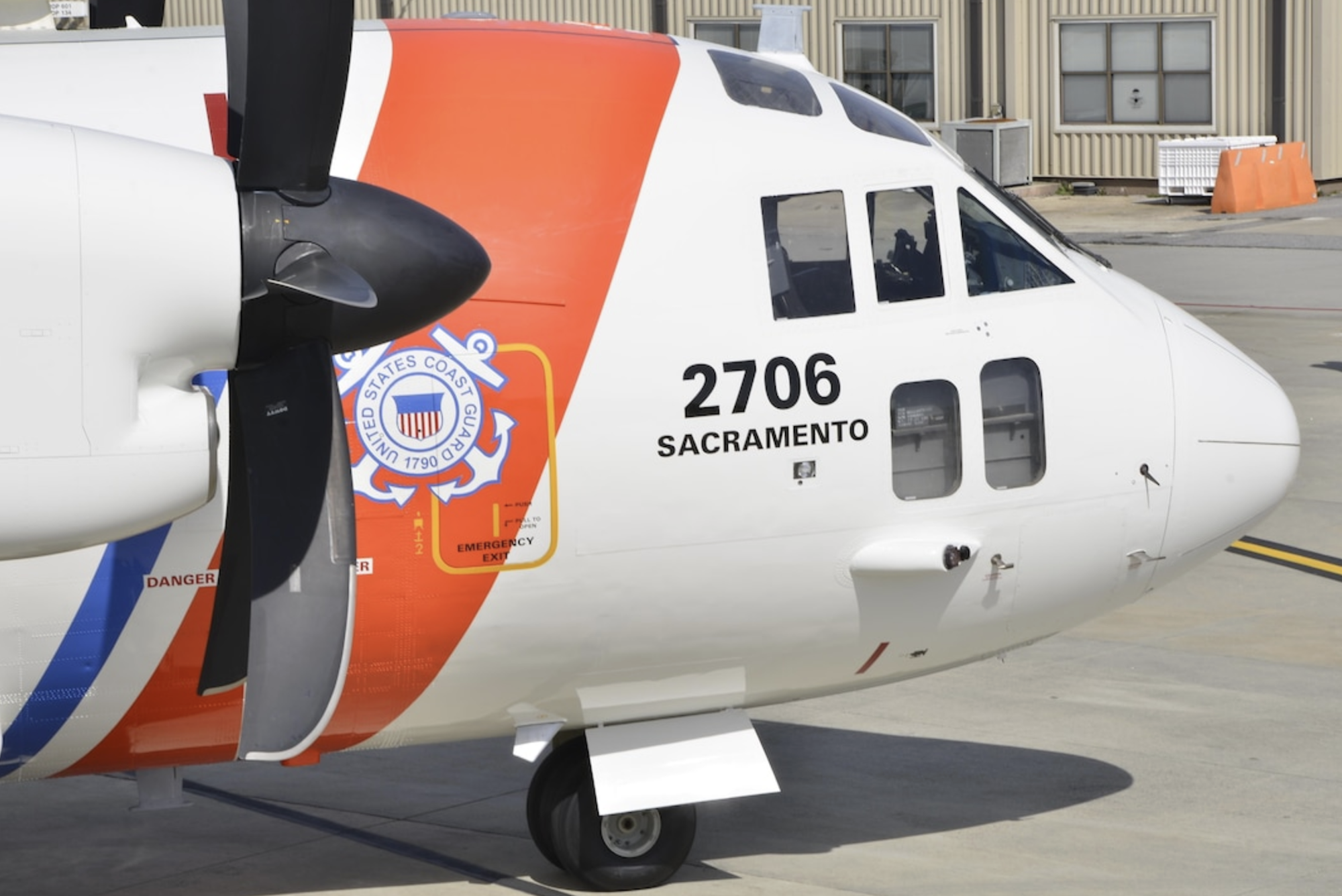 The image shows a U.S. Coast Guard aircraft with distinctive markings and the identifier "2706 Sacramento."
