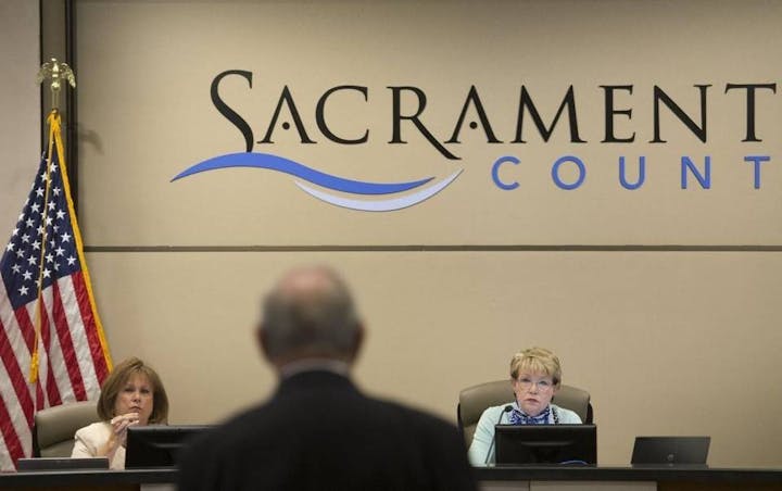 May contain: person, human, indoors, room, crowd, and audience