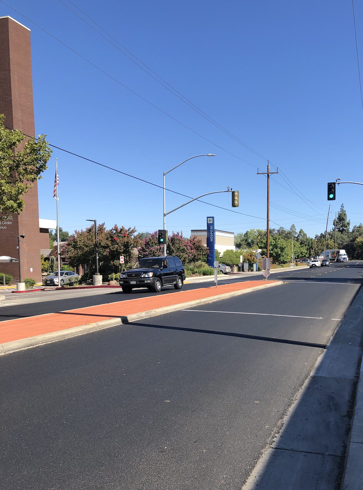 May contain: road, intersection, tarmac, asphalt, traffic light, and light
