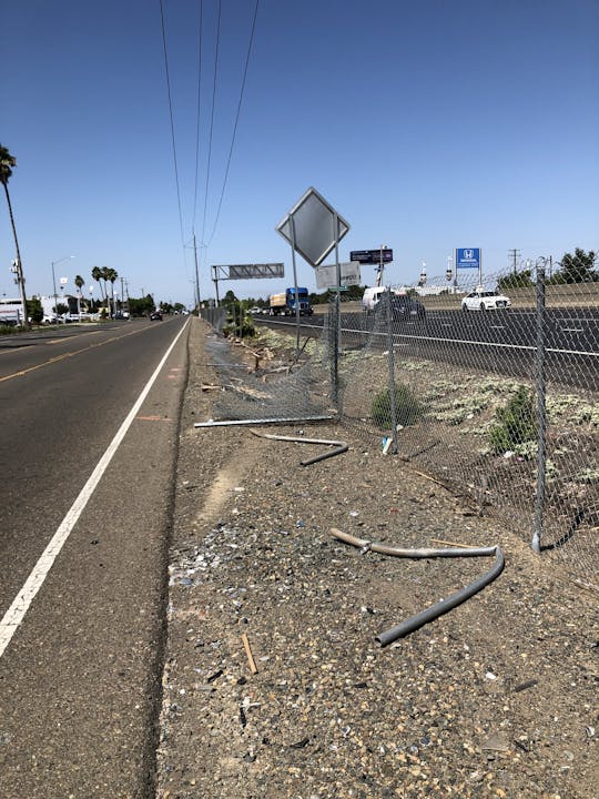 crash site with damaged fence