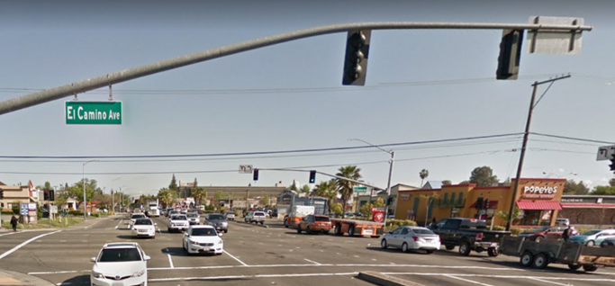 May contain: road, intersection, car, transportation, vehicle, automobile, traffic light, light, person, and human