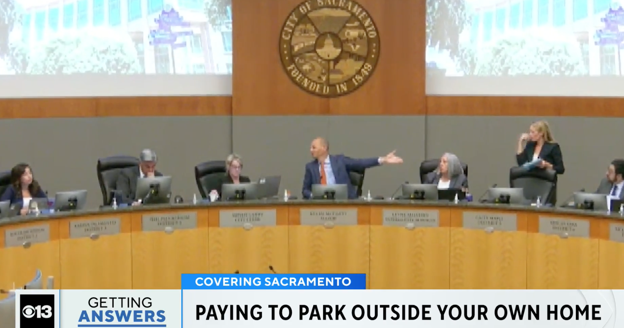 Sacramento City Council meeting discussing residential parking fees, with officials seated at a panel.