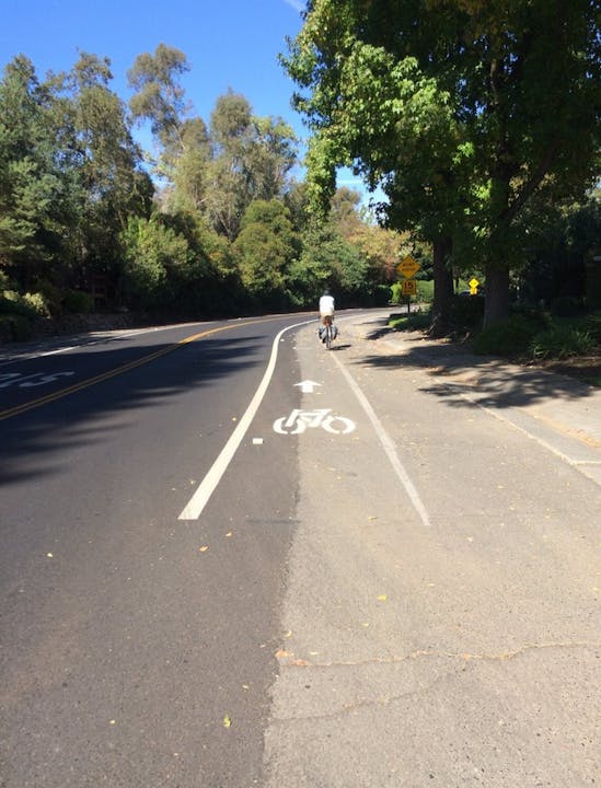 May contain: road, asphalt, tarmac, freeway, highway, bicycle, transportation, vehicle, bike, human, and person