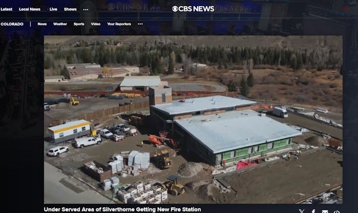 Aerial view of a construction site for a new fire station with equipment and vehicles around.