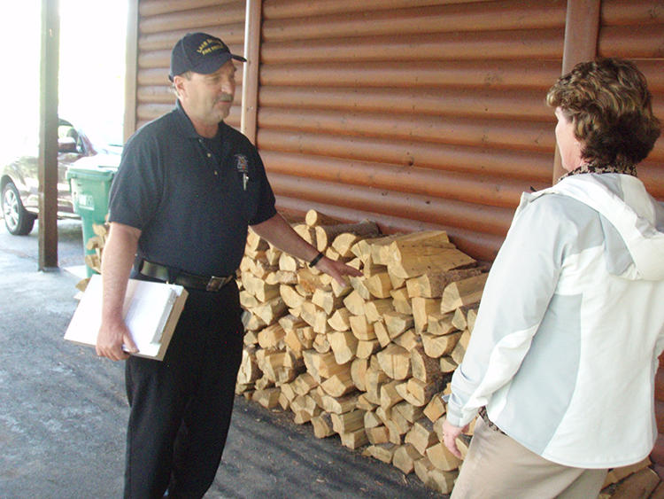 May contain: wood, lumber, baseball cap, cap, clothing, hat, adult, male, man, person, plywood, and box