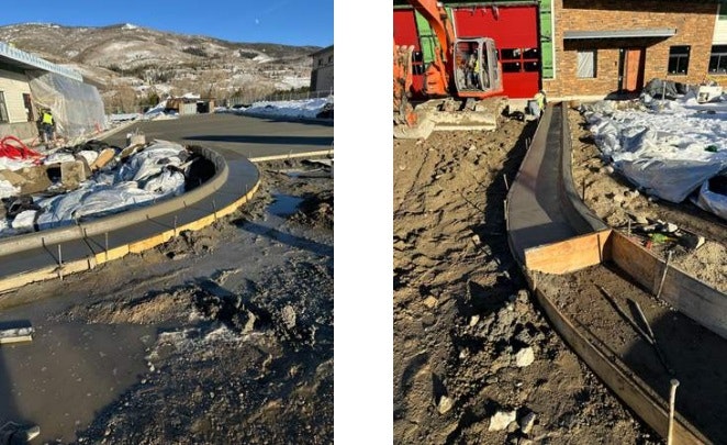 Construction site with curved concrete forms and muddy terrain.