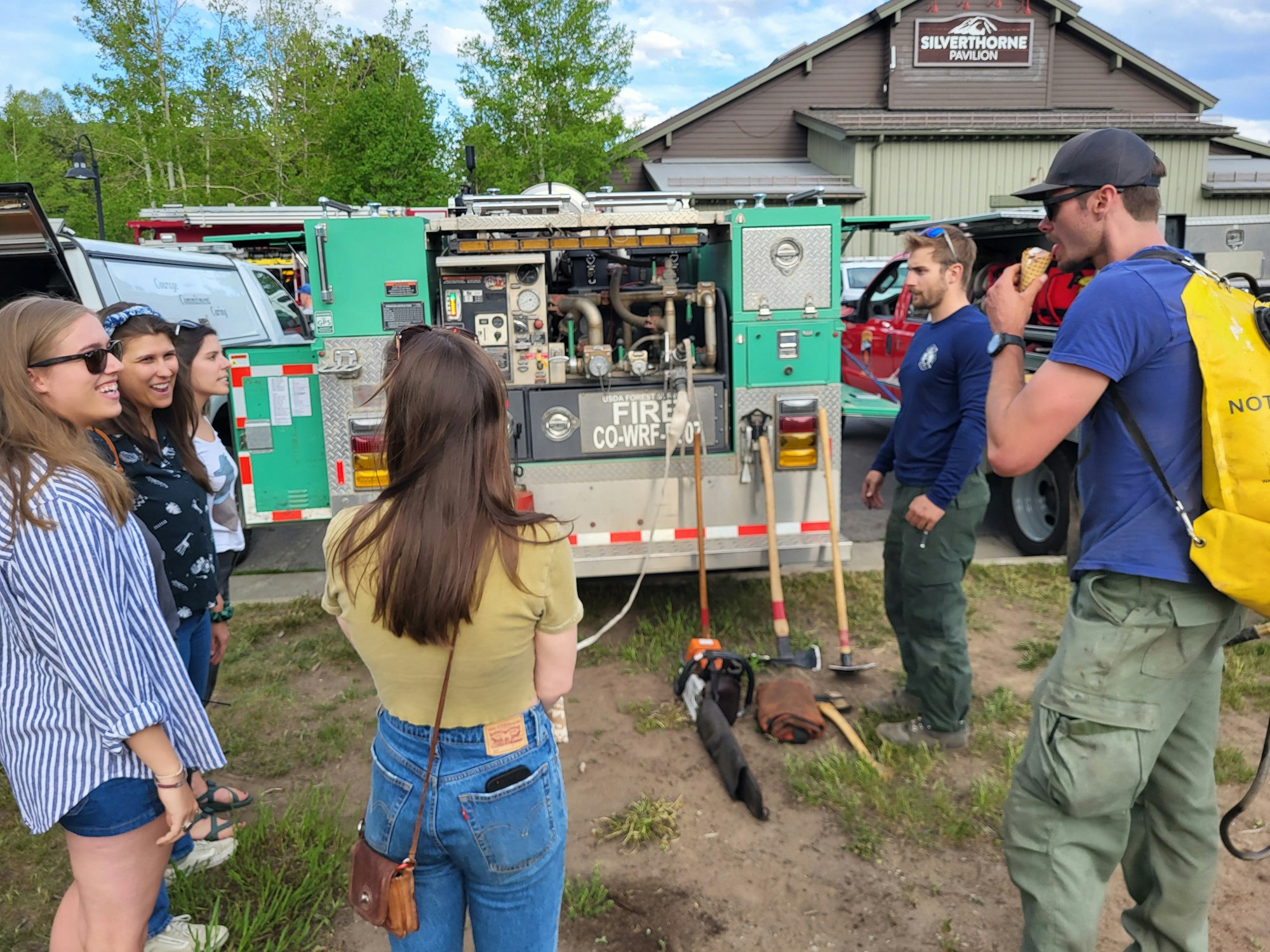 People gather around a fire truck and equipment, with firefighters nearby, outside a building labeled "Silverthorne Pavilion."
