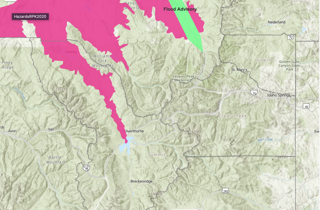 A map displaying areas under a flood advisory (green) and a pink area likely indicating some type of hazard warning or alert.