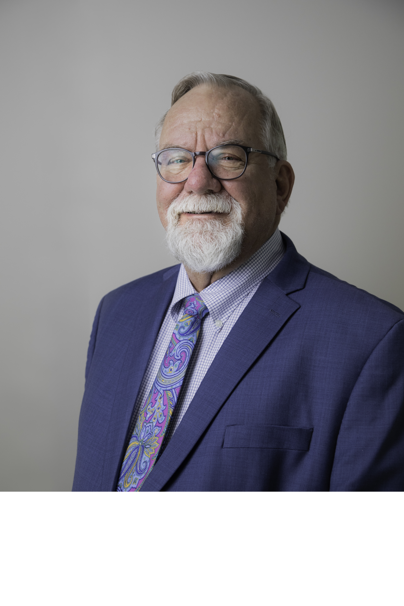 May contain: formal wear, tie, accessories, head, person, face, beard, suit, clothing, portrait, photography, man, adult, male, and glasses