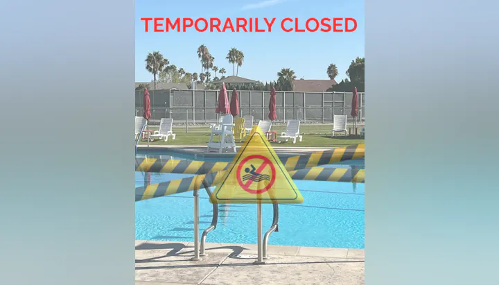 An outdoor pool area marked "Temporarily Closed," with a caution sign indicating no swimming allowed.