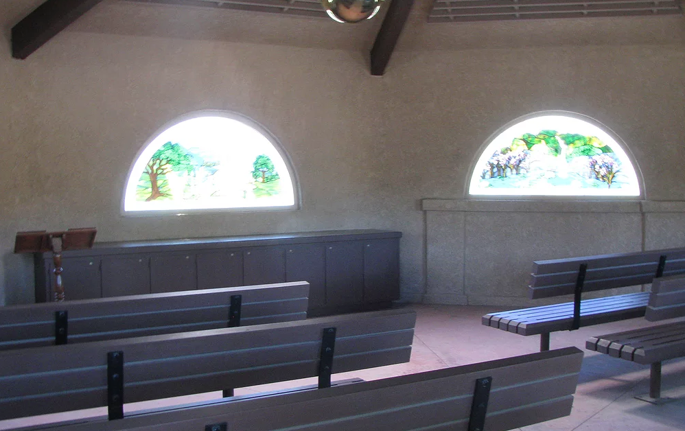May contain: bench, interior of chapel, stained glass windows