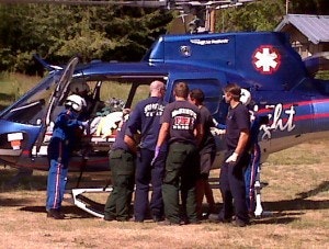 Firefighters loading a patient into a Lifeflight helicopter