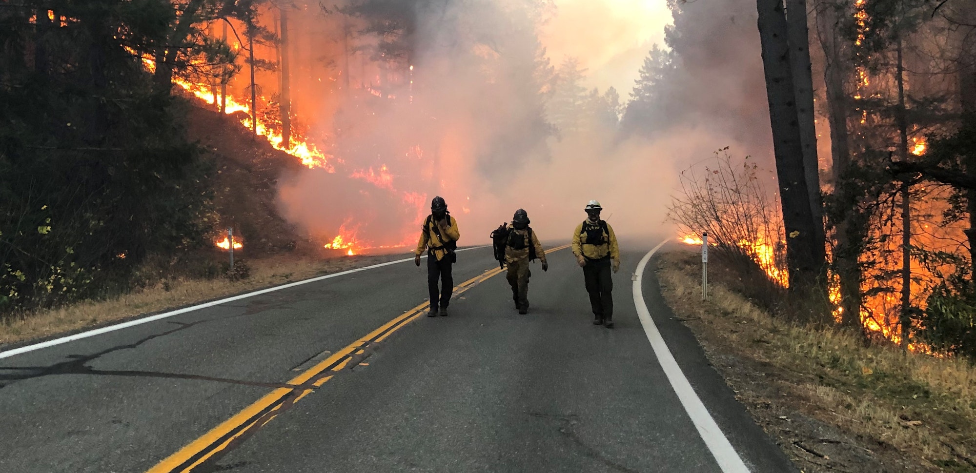 May contain: glove, clothing, person, fire, helmet, shoe, and footwear