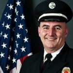 Lieutenant Jim Ellis in his class A uniform next to United States flag