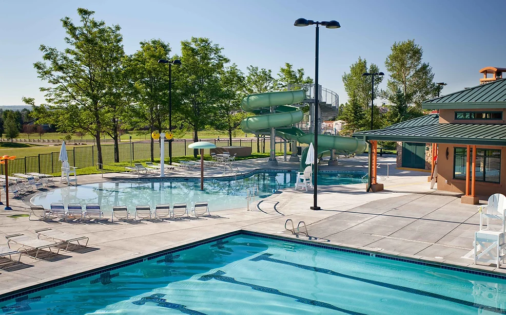 Photo of swimming pool, slide and building