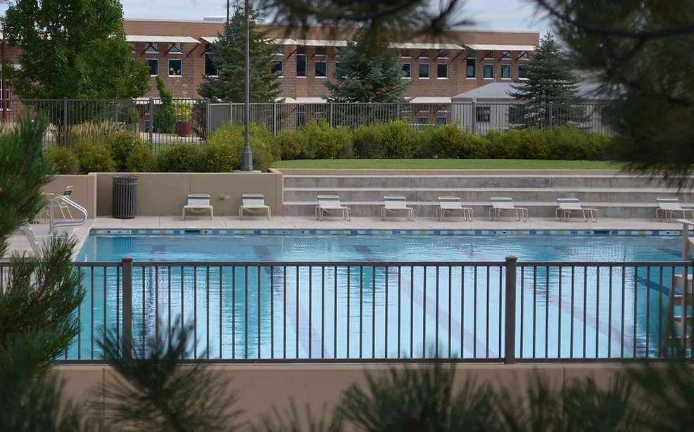 Photo of swimming pool and patio furniture