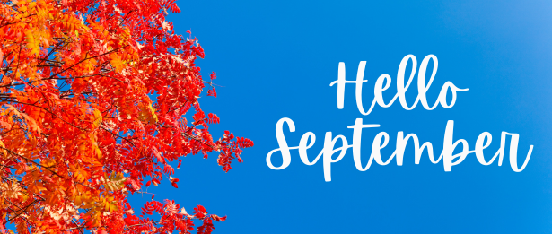 Blue sky background with red autumn leaves and the phrase "Hello September".