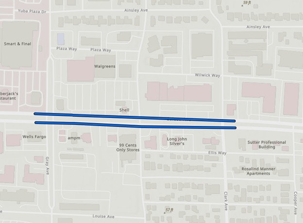 The image shows a map highlighting two blue lines along a road, with nearby businesses and streets labeled.