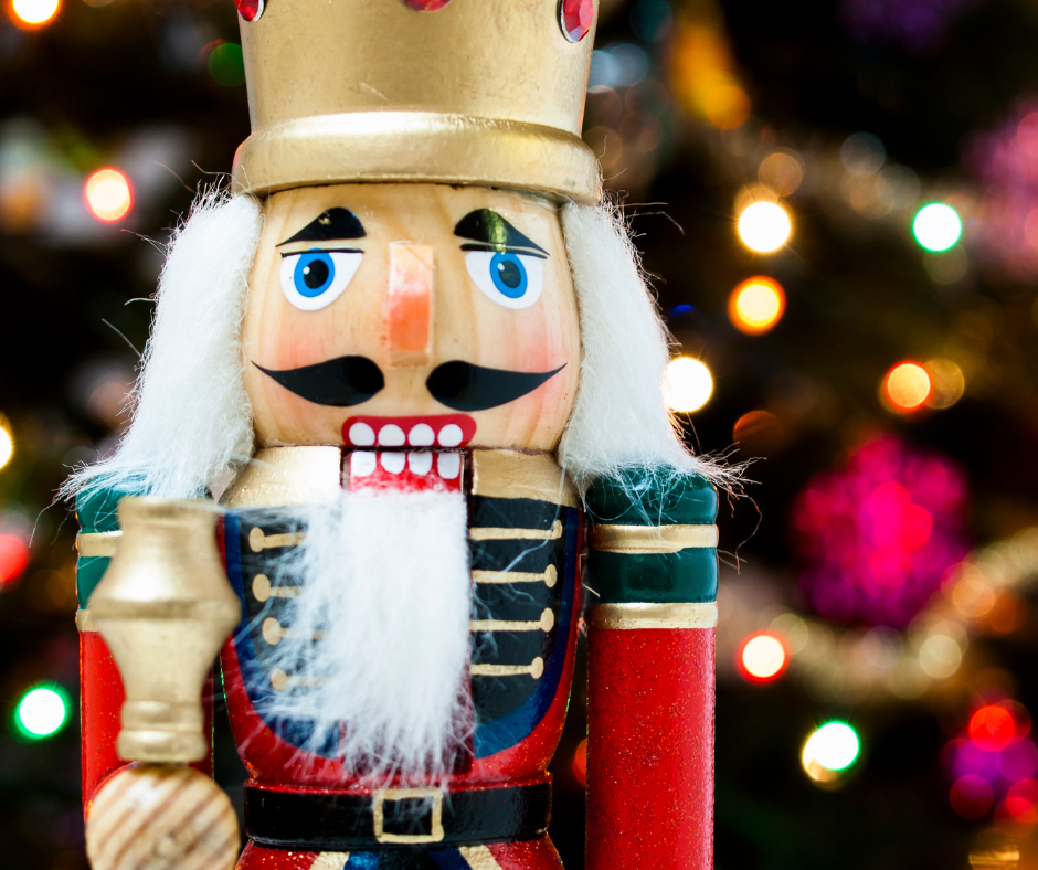 A colorful nutcracker figurine with bokeh lights in the background.
