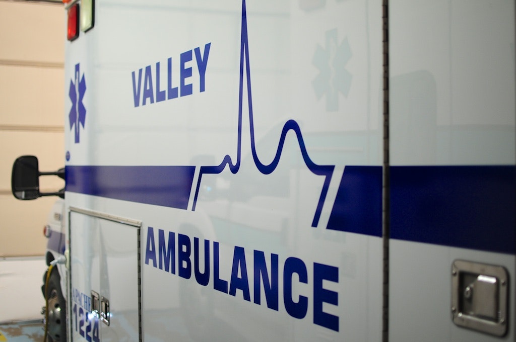 Side view of an ambulance with "Valley Ambulance" and a heartbeat graphic on it.