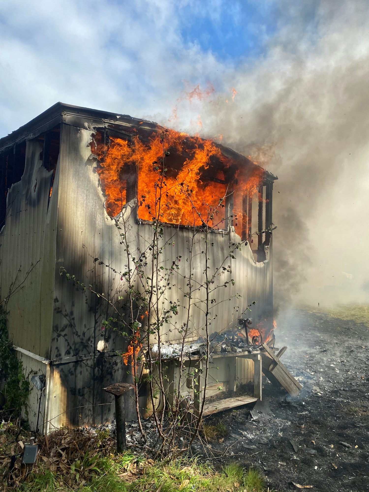 Large flames burning mobile home
