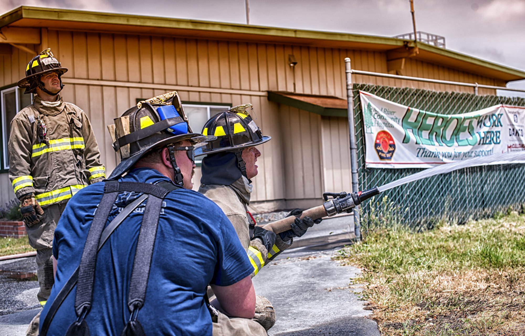 May contain: person, human, helmet, clothing, apparel, fireman, gun, weapon, and weaponry