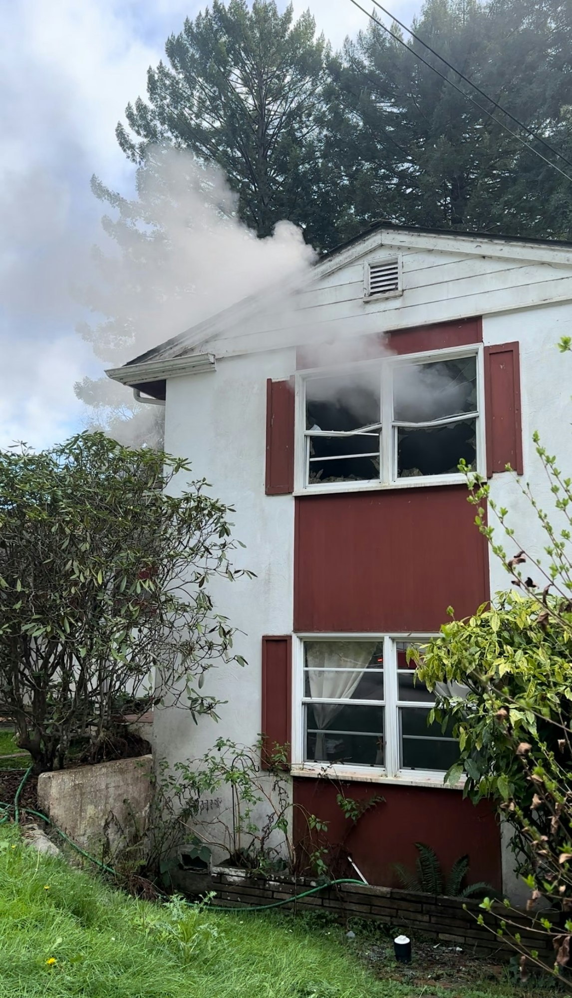 House with smoke coming from the 2nd story bedroom.